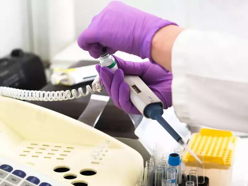 close up of hands using equipment in the core genetics lab